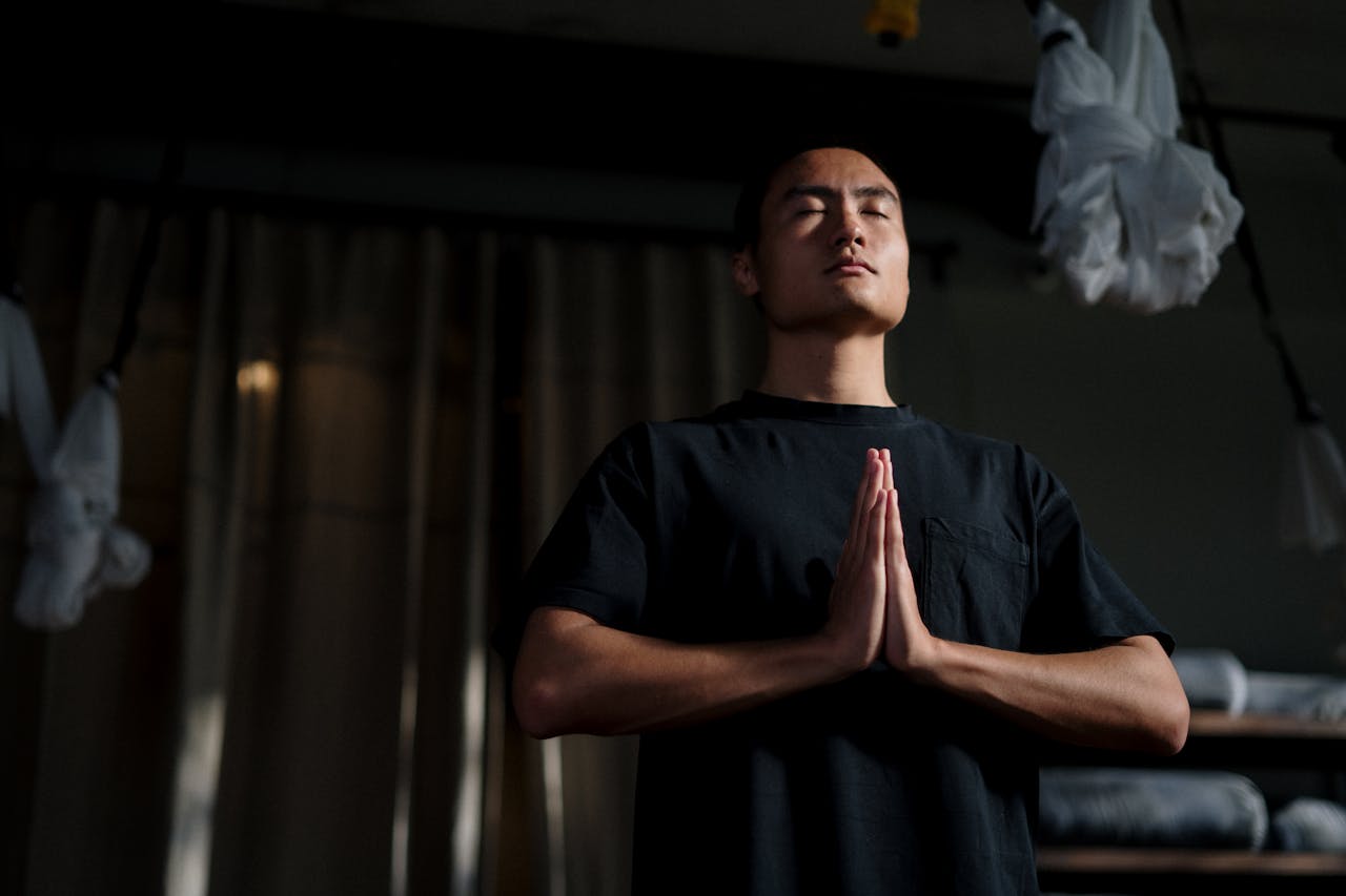 The Art of Drawing Readers In: Your attractive post title goes here An adult male practicing meditation in a yoga studio, focusing on mindfulness and wellbeing.